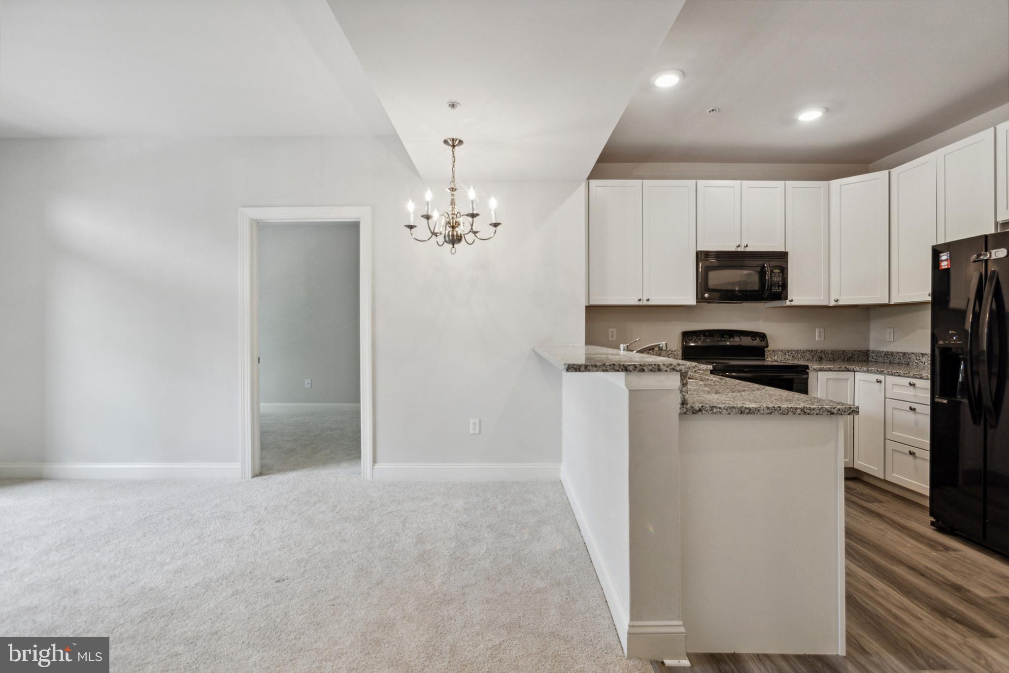 3000 Fountainview Circle, Unit 3311 Newark, DE 19713 - Photo 15 of 32 a kitchen with a refrigerator and a stove top oven