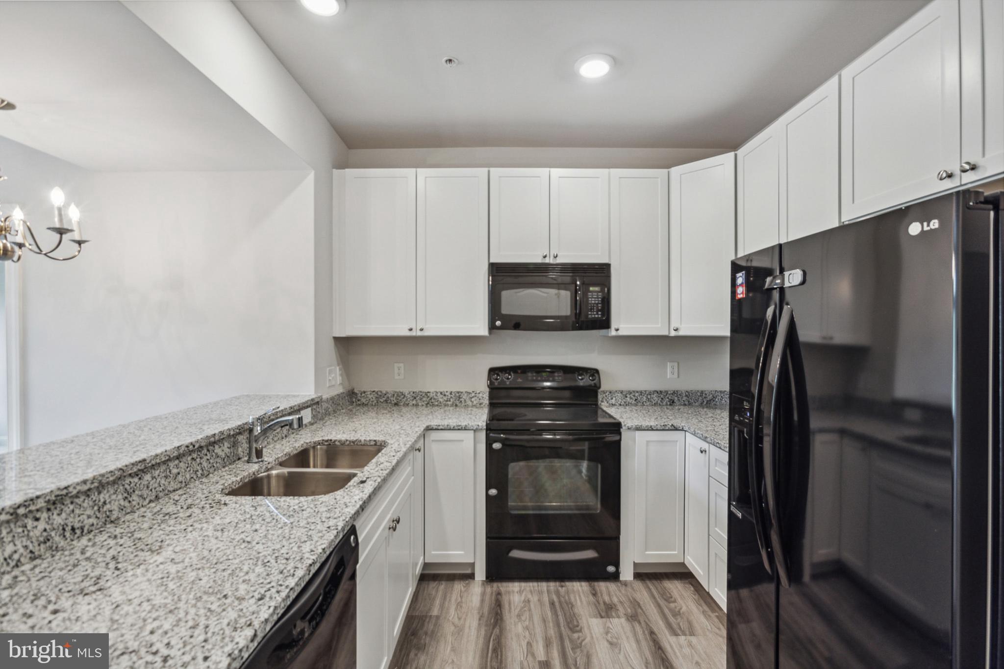 3000 Fountainview Circle, Unit 3311 Newark, DE 19713 - Photo 17 of 32 a kitchen with a sink stove and refrigerator