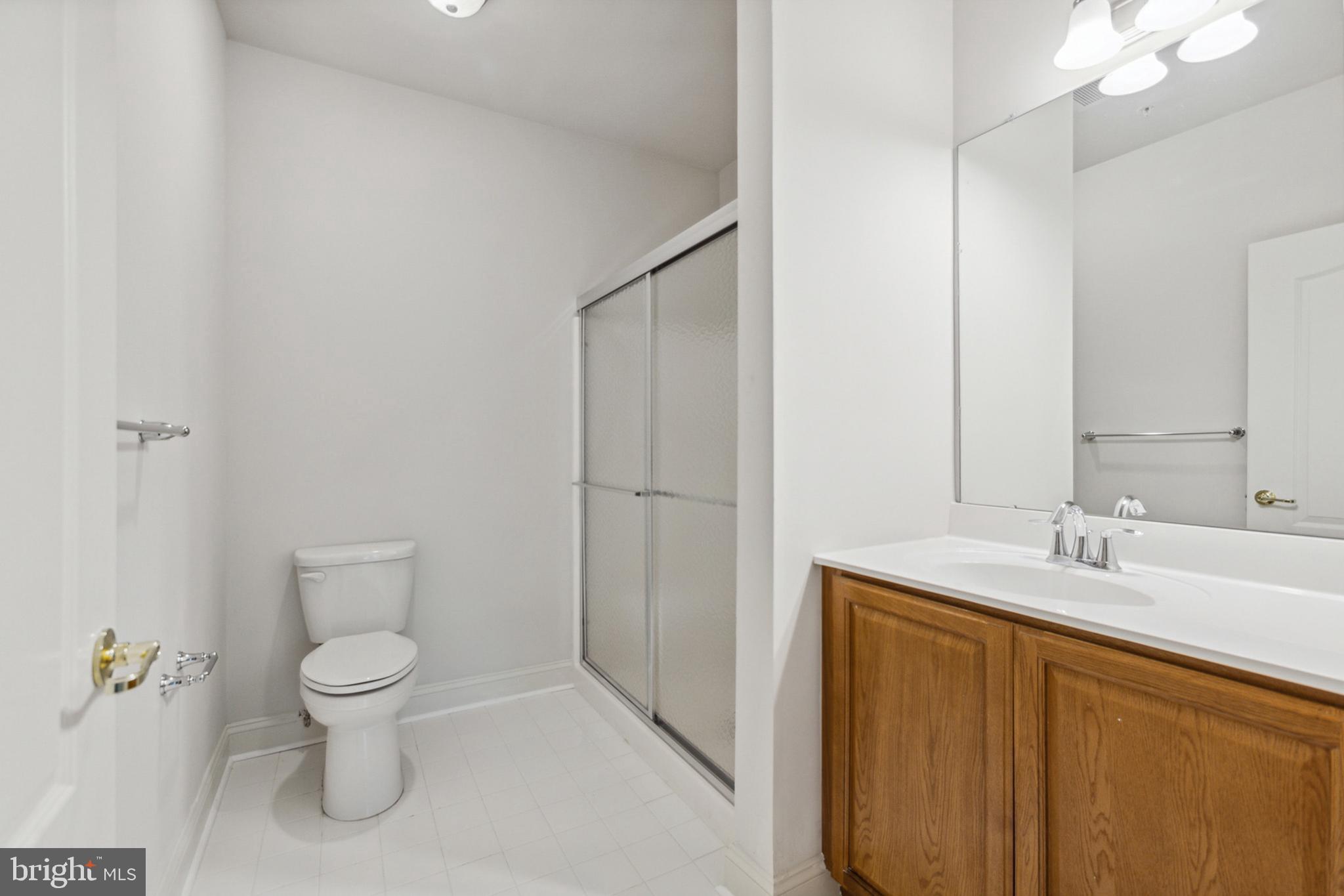 3000 Fountainview Circle, Unit 3311 Newark, DE 19713 - Photo 21 of 32 a bathroom with a granite countertop sink a toilet and a mirror