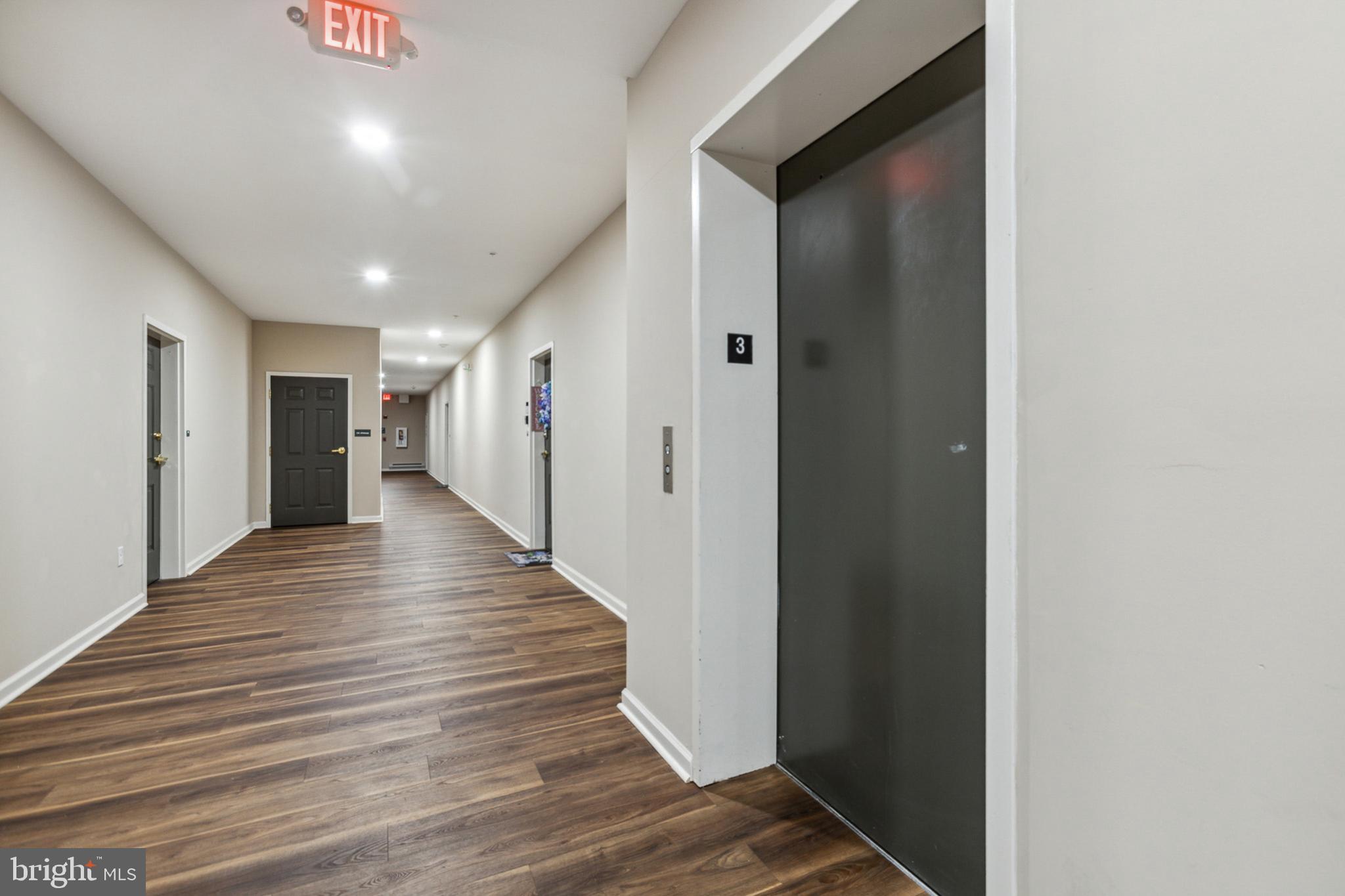 3000 Fountainview Circle, Unit 3311 Newark, DE 19713 - Photo 8 of 32 a view of a hallway with wooden floor