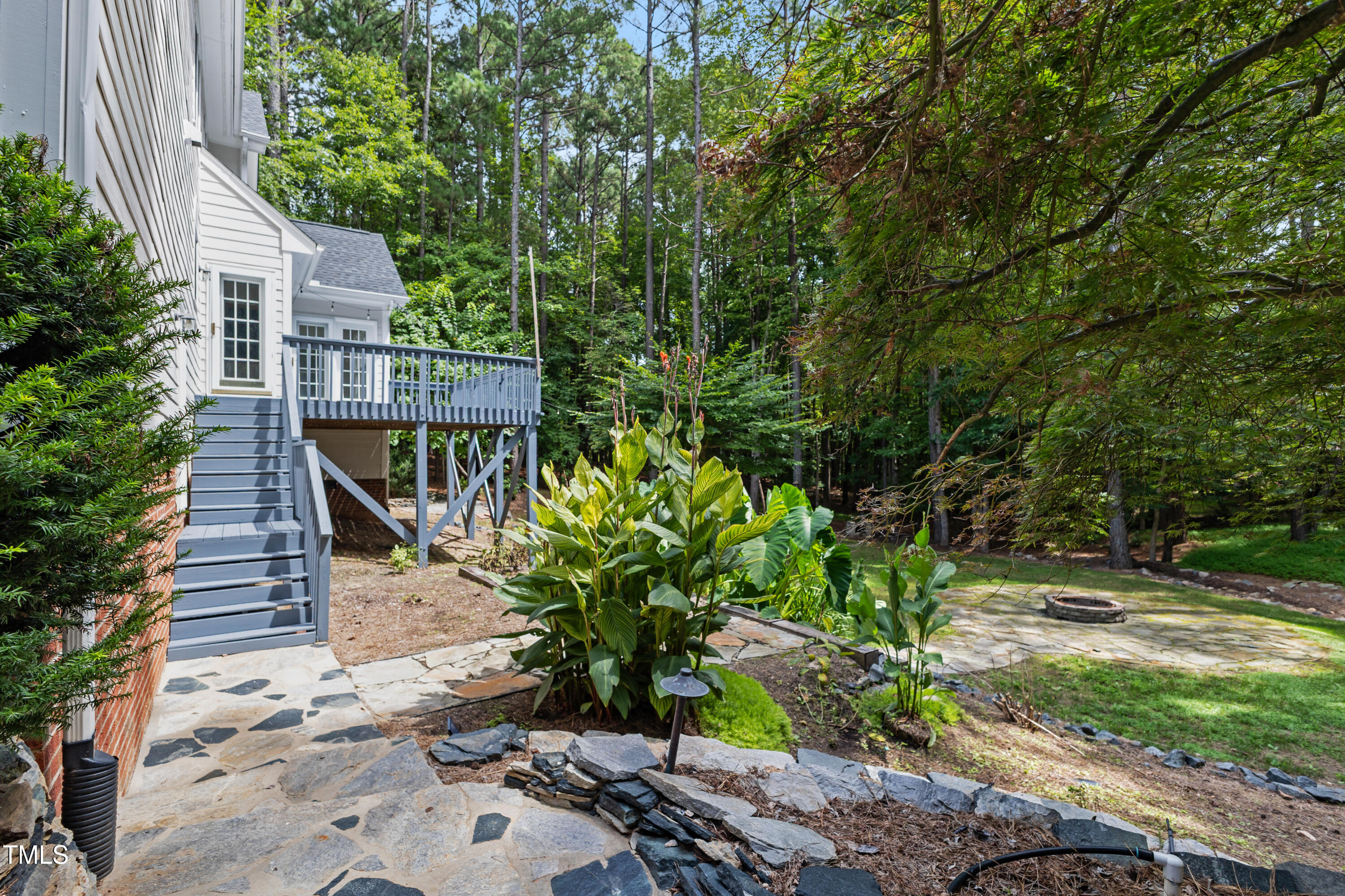 5809 North Hawthorne Way Raleigh, NC 27613 - Photo 5 of 32 a house with trees in front of it