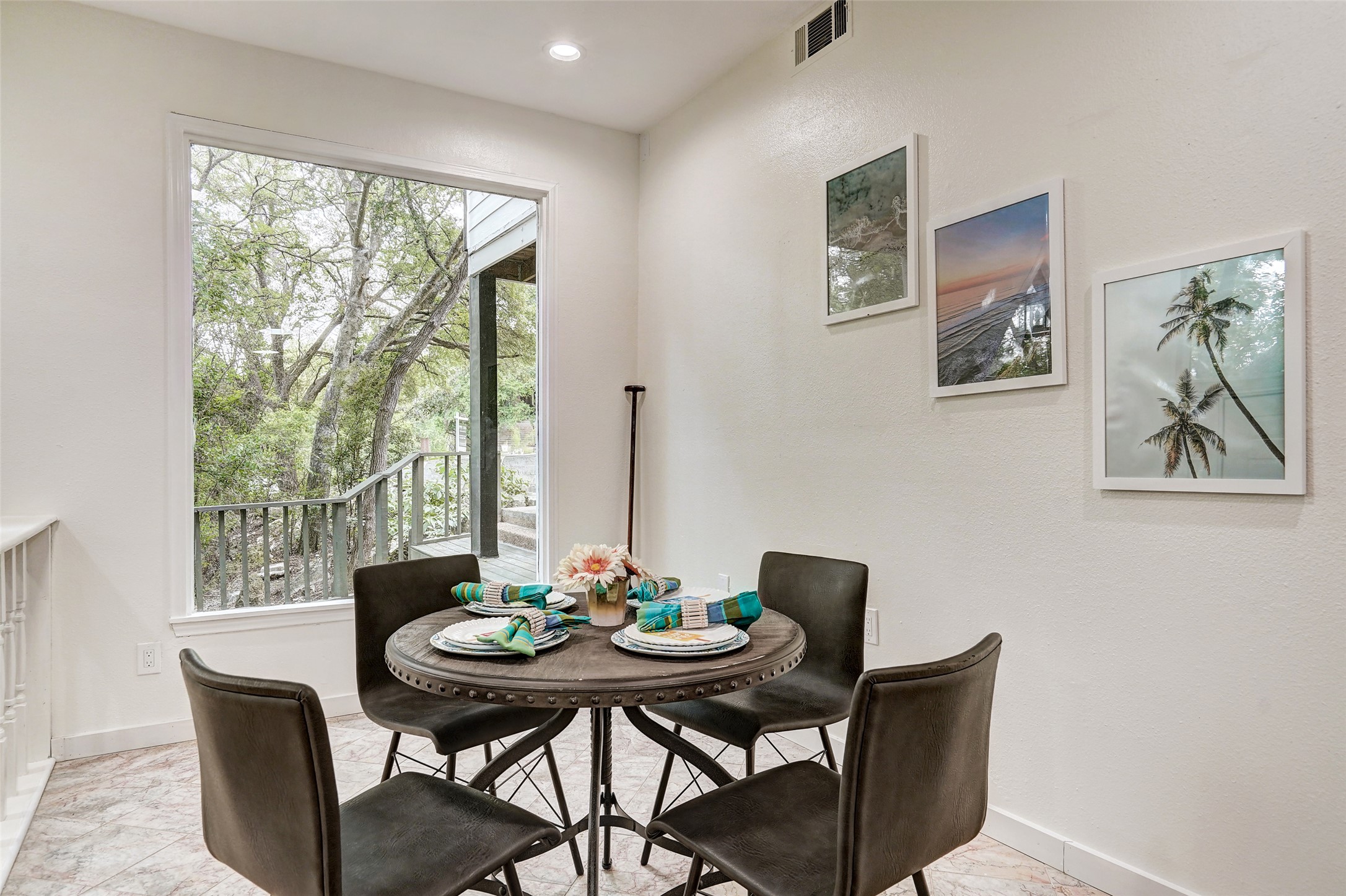 8804 Mountain Ridge Drive, Unit B Austin, TX 78759 - Photo 5 of 17 A cozy dining area with ample natural light from the large picture window, offering views of the surrounding natural landscape.
