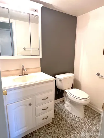 a bathroom with a sink a toilet and a mirror
