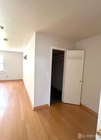 a view of an empty room and wooden floor