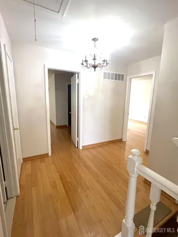 a view of a room with wooden floor and staircase