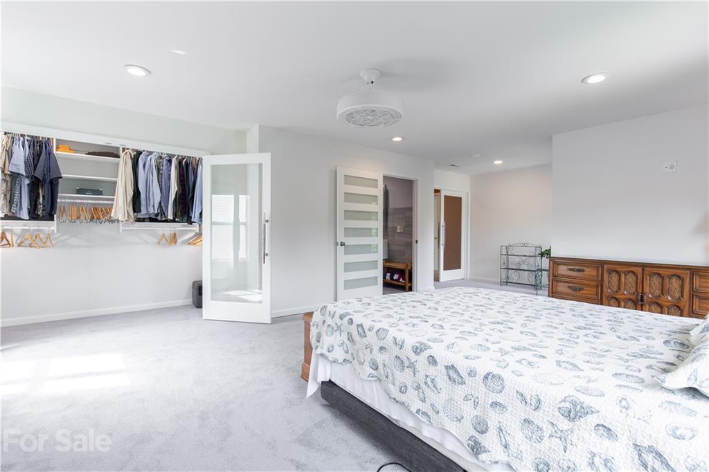 321 Allspice Road Fort Mill, SC 29708 - Photo 8 of 29 a bedroom with a large bed closet and flat screen tv