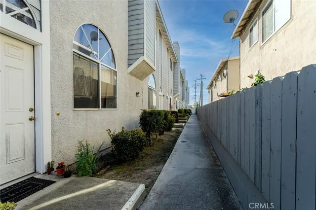a view of a pathway along the path along with potted plants