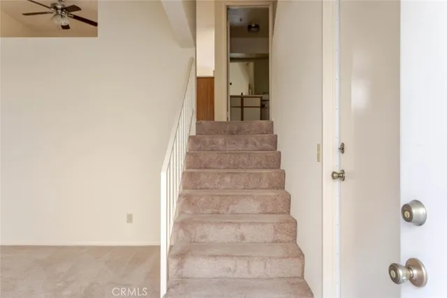a view of staircase with white walls