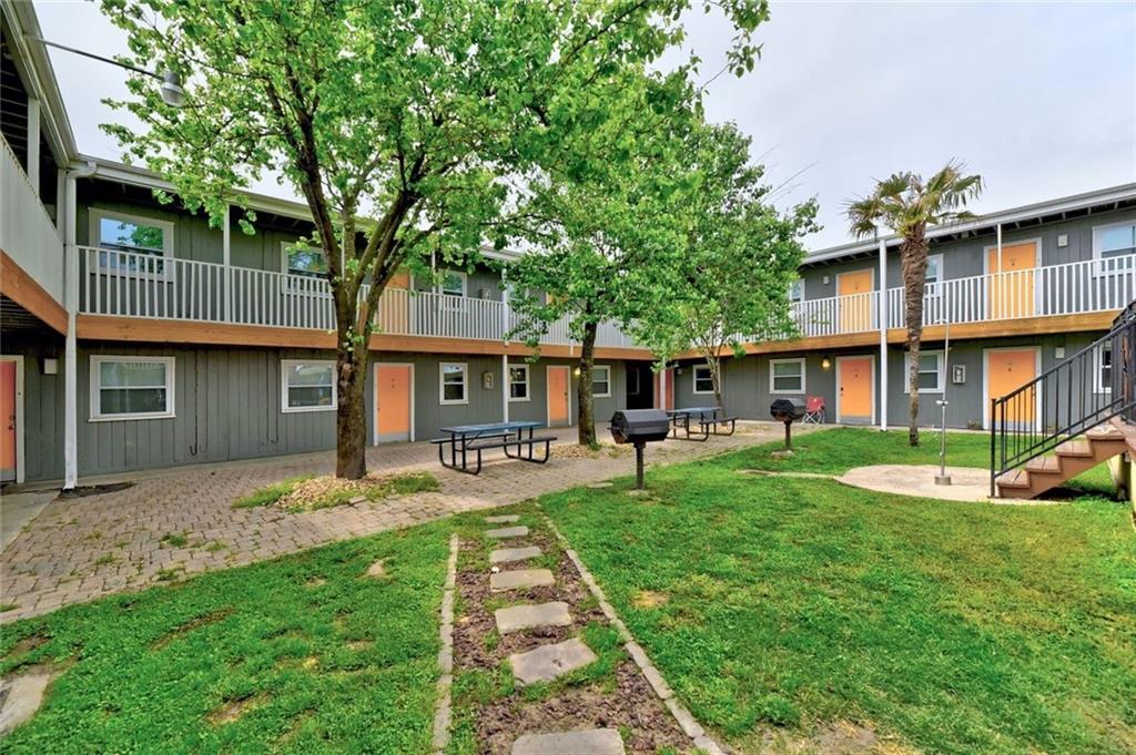 2401 Manor Road, Unit 221 Austin, TX 78722 - Photo 20 of 21 A verdant courtyard provides a welcoming green space within this multi-level residential complex.