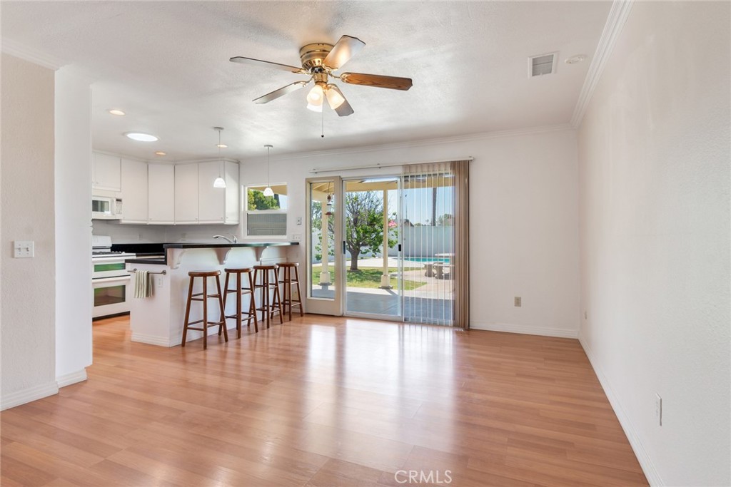 9130 Duncan Avenue Riverside, CA 92503 - Photo 12 of 34 a view of kitchen with stainless steel appliances refrigerator oven dining table and chairs
