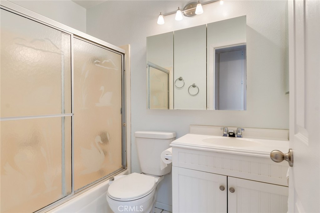 9130 Duncan Avenue Riverside, CA 92503 - Photo 19 of 34 a bathroom with a sink a mirror a toilet and shower
