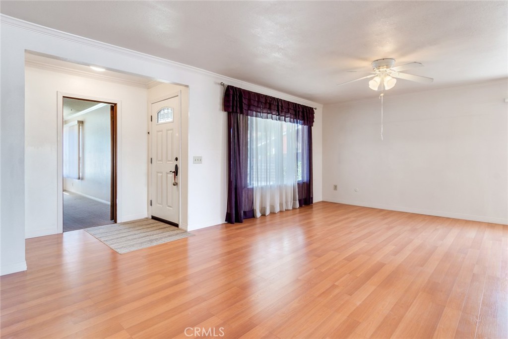 9130 Duncan Avenue Riverside, CA 92503 - Photo 4 of 34 a view of a livingroom with wooden floor and a ceiling fan