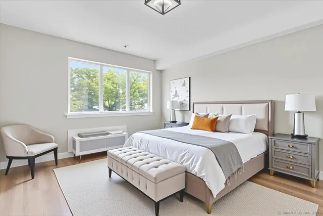 a bedroom with a bed and a chair