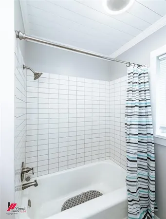 a bathroom with a bathtub and shower