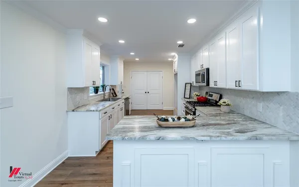 a kitchen with counter top space cabinets and appliances