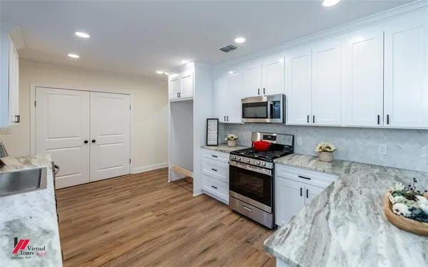a kitchen with granite countertop a stove and a sink