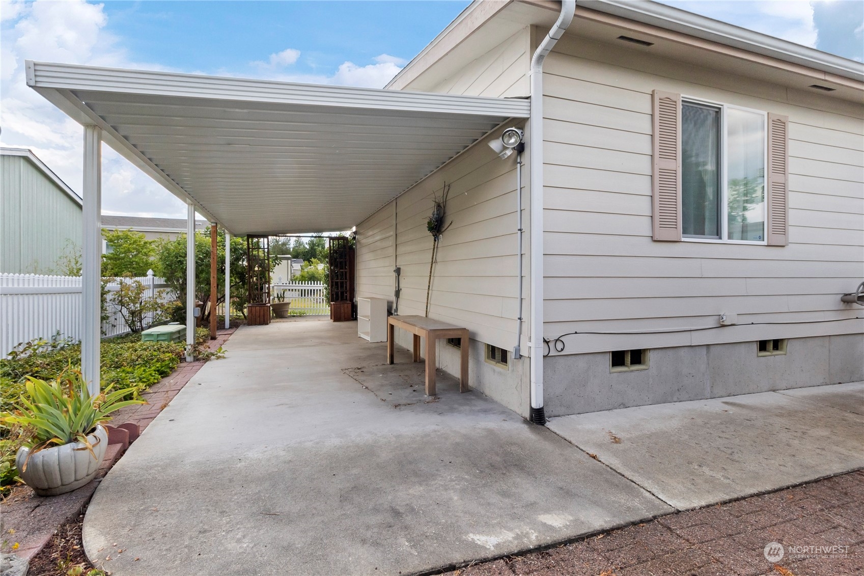 1208 Spruce Drive Enumclaw, WA 98022 - Photo 22 of 25 a view of a patio with table and chairs potted plants with wooden fence