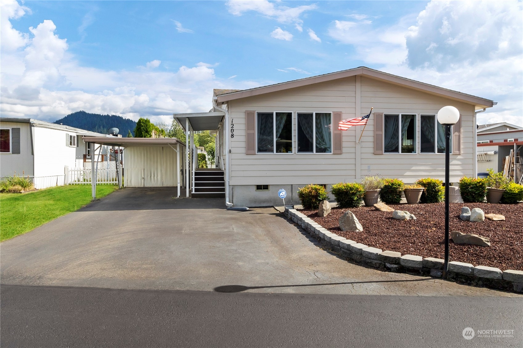 1208 Spruce Drive Enumclaw, WA 98022 - Photo 23 of 25 a front view of a house with a garden and plants