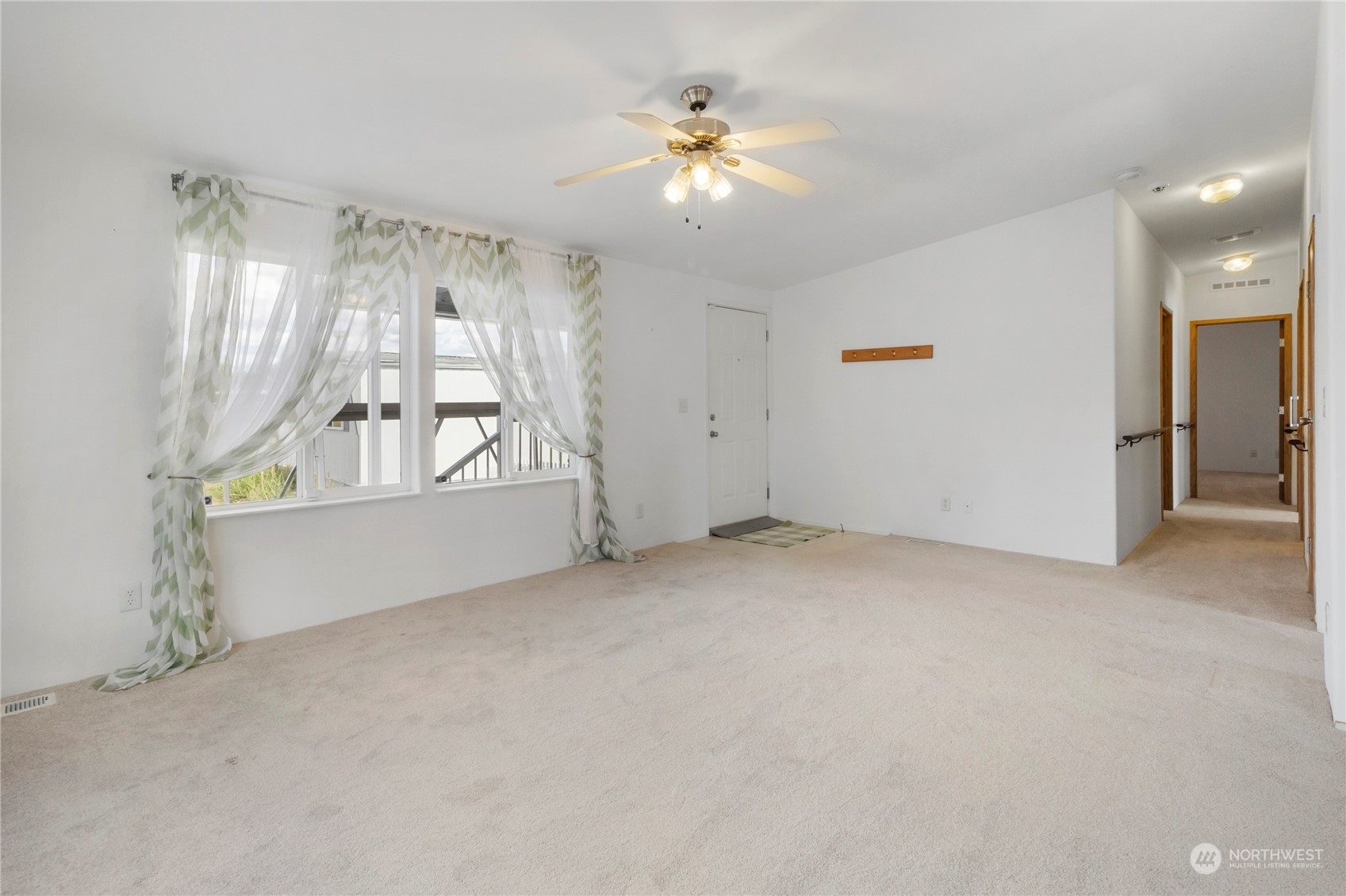 1208 Spruce Drive Enumclaw, WA 98022 - Photo 3 of 25 an empty room with windows and chandelier fan