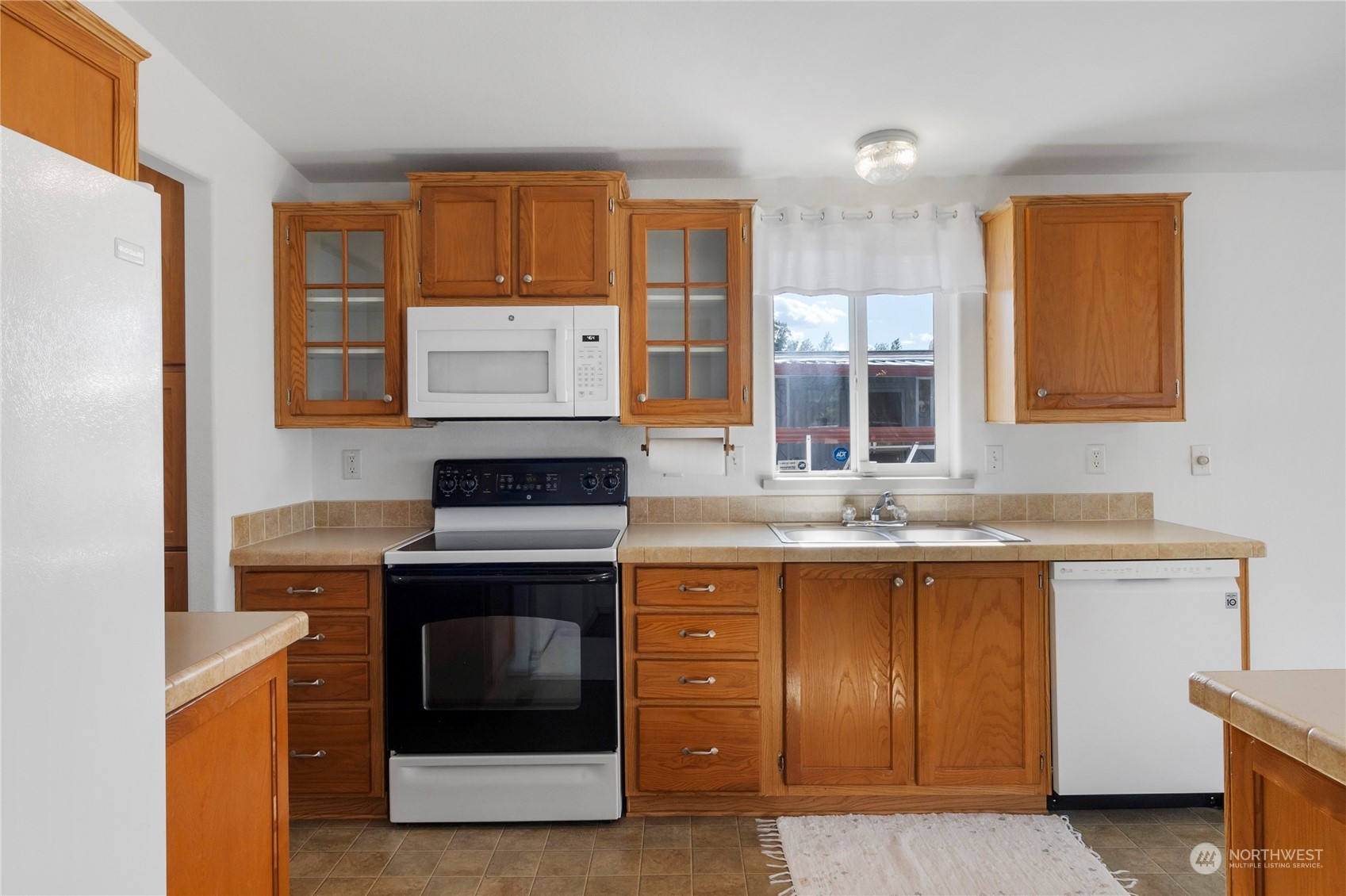 1208 Spruce Drive Enumclaw, WA 98022 - Photo 6 of 25 a kitchen with stainless steel appliances granite countertop a stove and a sink