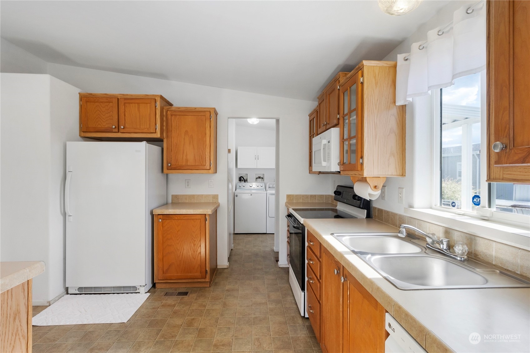 1208 Spruce Drive Enumclaw, WA 98022 - Photo 7 of 25 a kitchen with stainless steel appliances granite countertop a sink stove and refrigerator