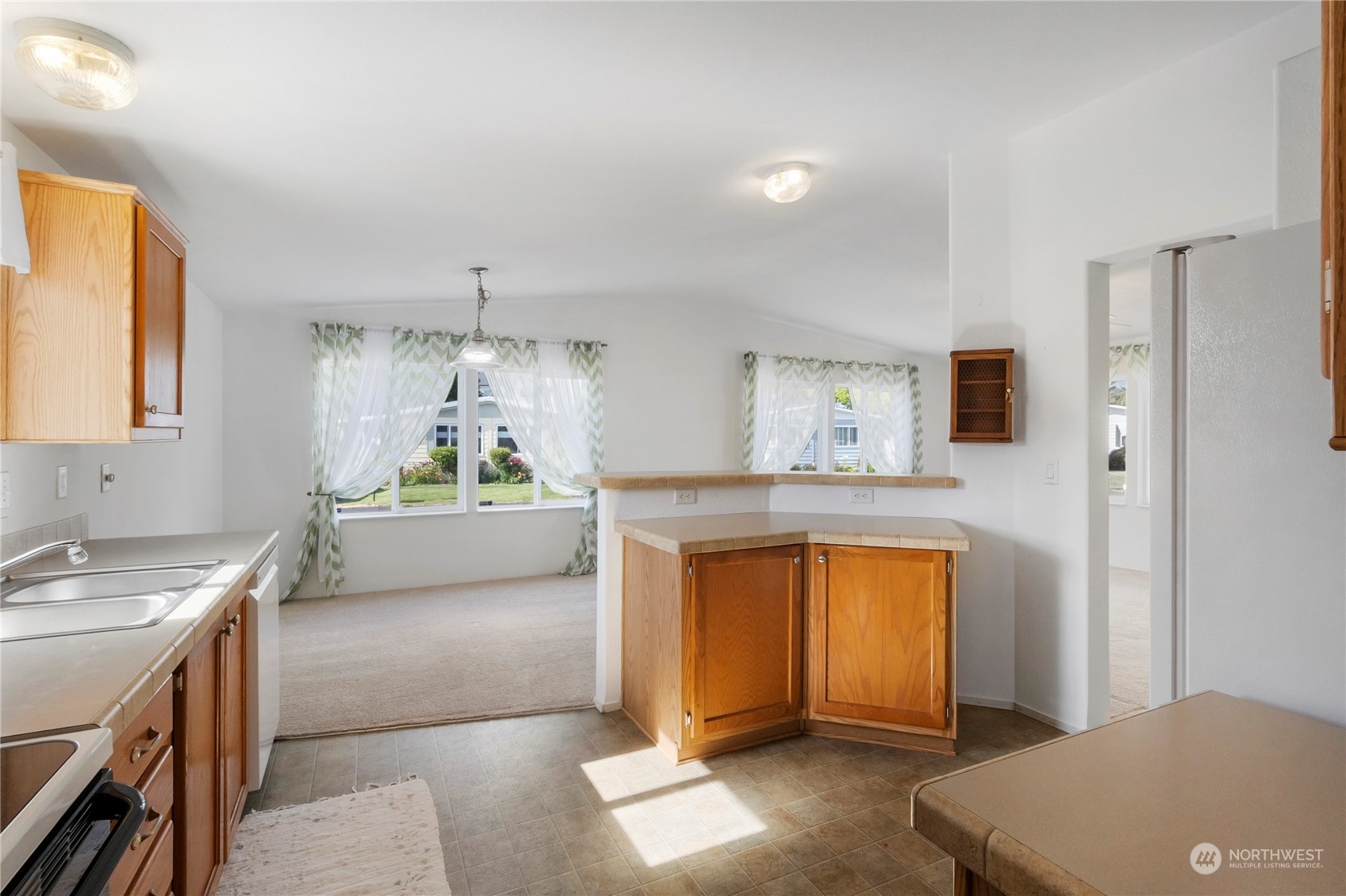 1208 Spruce Drive Enumclaw, WA 98022 - Photo 8 of 25 a kitchen with stainless steel appliances granite countertop a stove a sink and a refrigerator