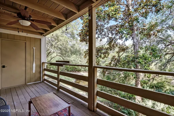 a view of a two room with wooden floor and outdoor seating