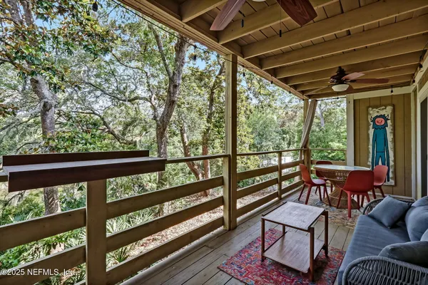 a view of a chairs and table in the balcony