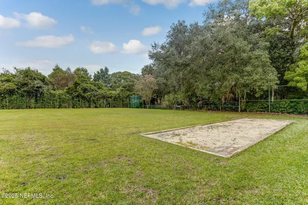 a view of a field with an trees
