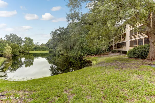 a view of a lake with a house in the background