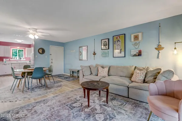 a living room with furniture and wooden floor
