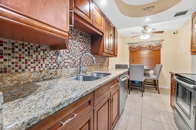 a kitchen with a sink stove and cabinets
