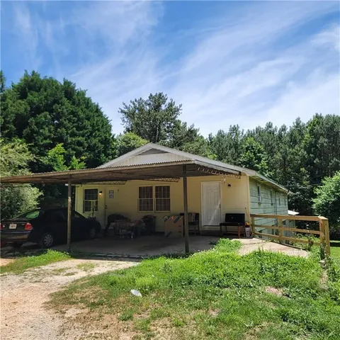 a backyard of a house with yard barbeque oven and outdoor seating