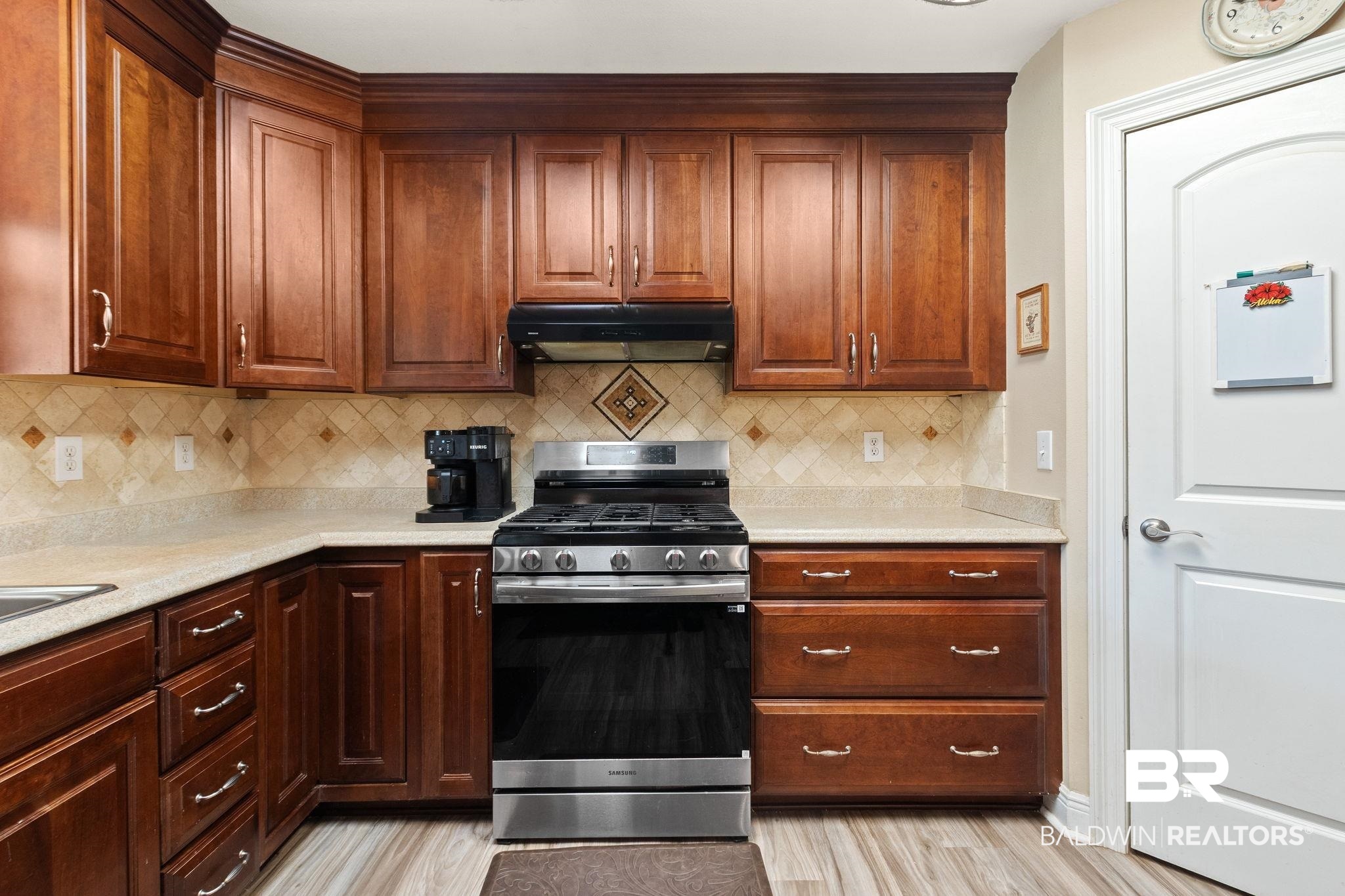 24250 Hack Road Bay Minette, AL 36507 - Photo 16 of 88 Kitchen featuring gas stove, backsplash, and light wood-type flooring