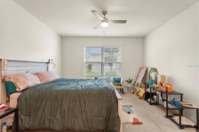 a bed sitting in a bedroom next to a window