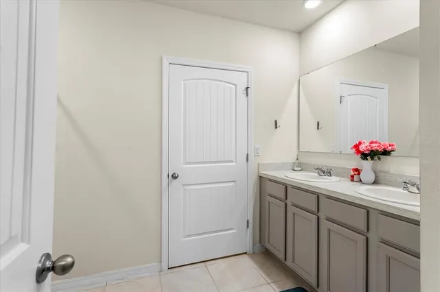 a bathroom with a sink vanity and a mirror