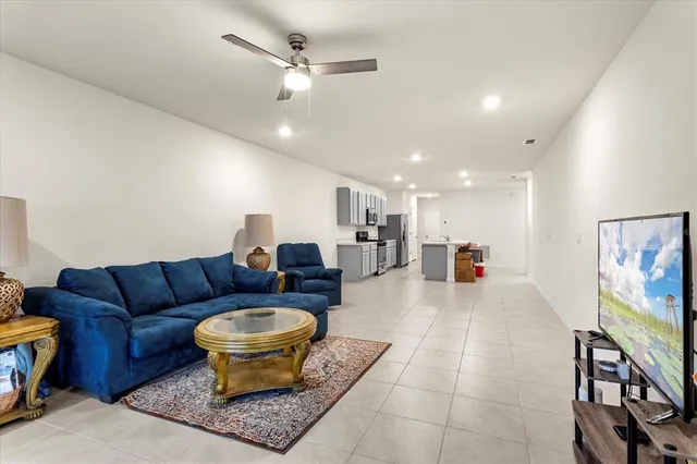 a living room with furniture a rug and a chandelier