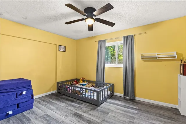 a bedroom with a bed and wooden floor