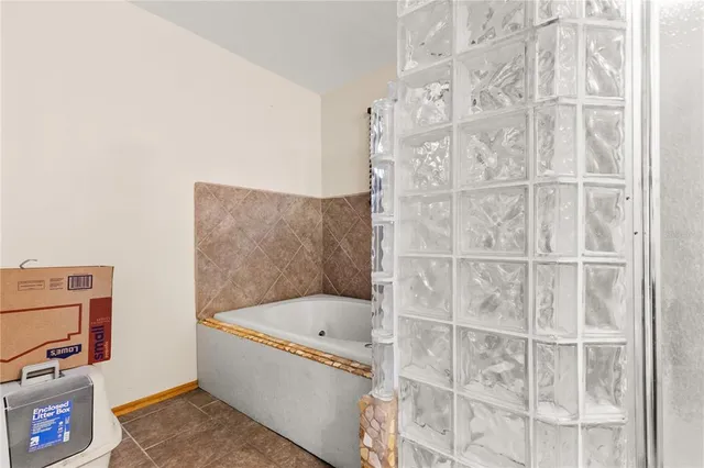 a bathroom with a bathtub and shower