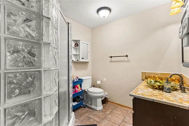 a white toilet sitting next to a bathroom sink