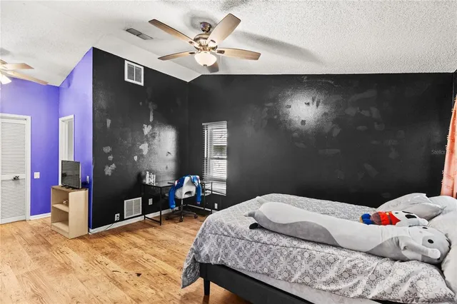 a bedroom with a bed and a chandelier