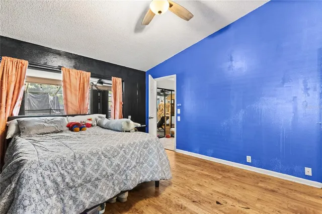 a bedroom with a bed and wooden floor