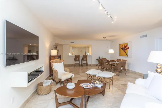 a living room with furniture a flat screen tv and a large window