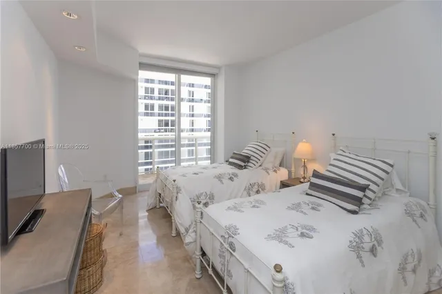 a spacious bathroom with a mirror sink and toilet