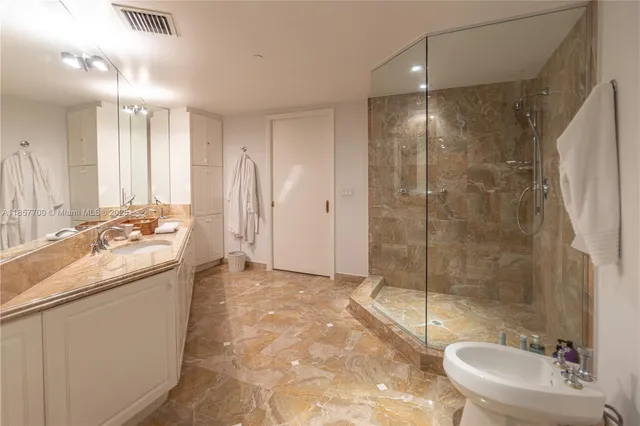 a bathroom with a toilet sink and shower