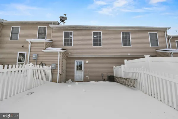 a view of a house with wooden fence