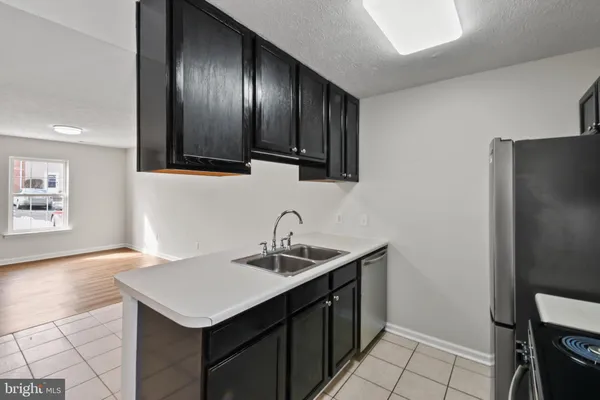 a kitchen with a sink cabinets and stainless steel appliances