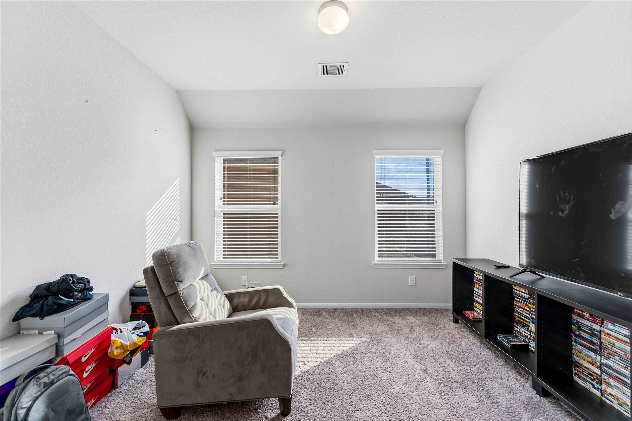 14810 Ruddy Duck Lane Houston, TX 77049 - Photo 18 of 28 a living room with furniture a window and a flat screen tv