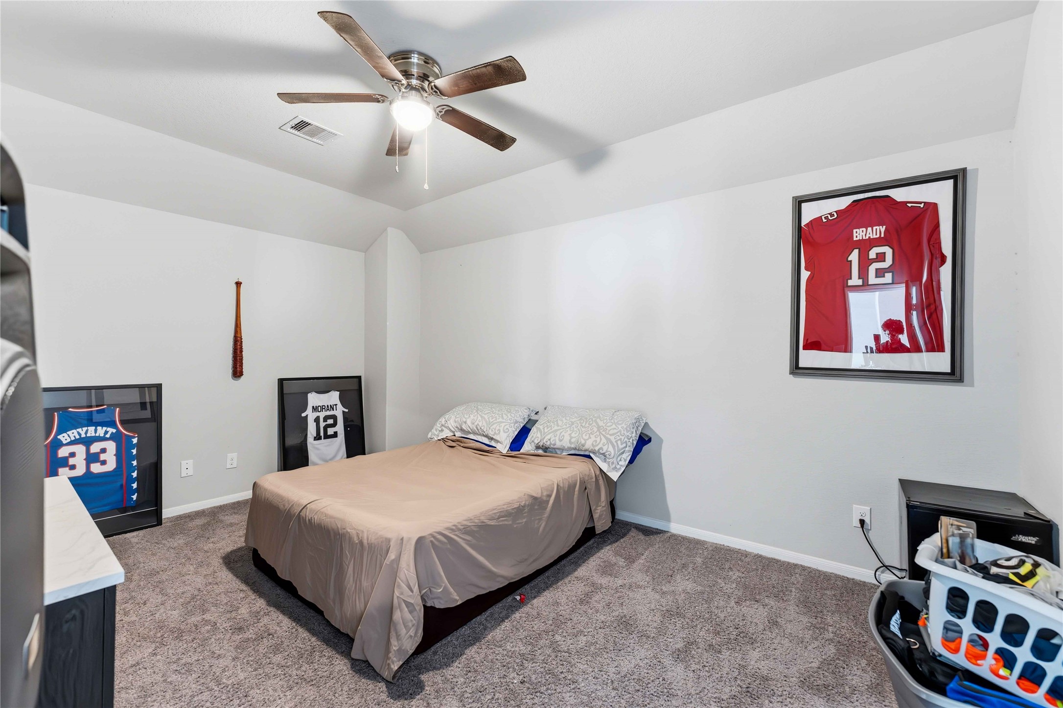 14810 Ruddy Duck Lane Houston, TX 77049 - Photo 20 of 28 a bedroom with a bed and a chandelier