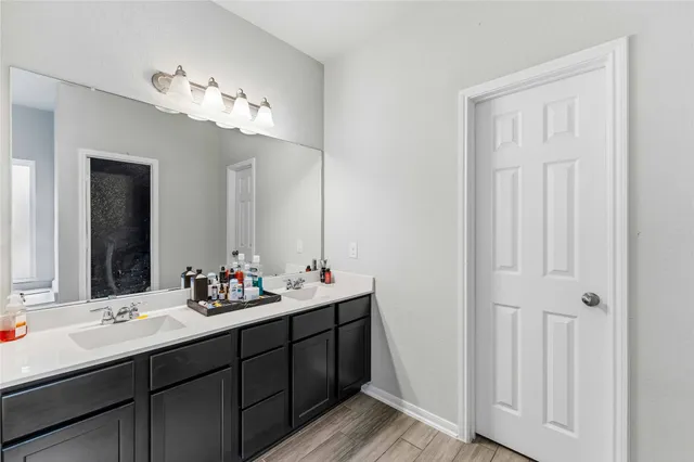 a bathroom with a double vanity sink and a mirror